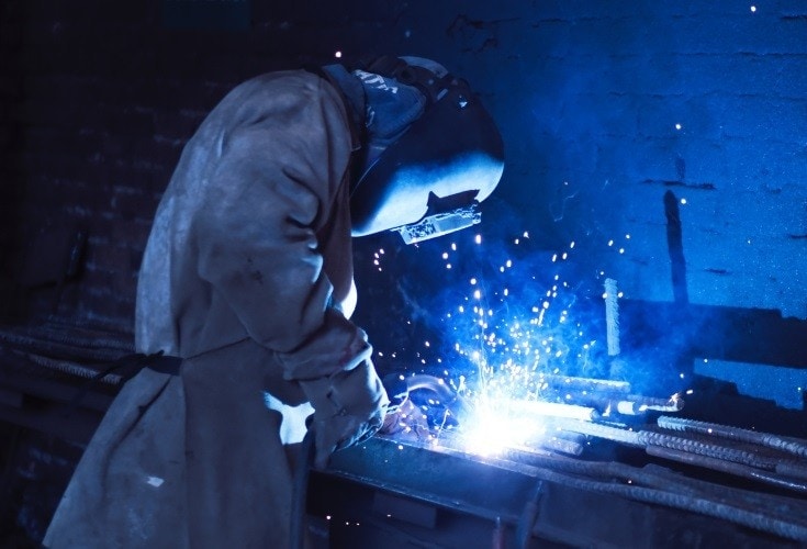 a man wearing an auto-darkening welding helmet