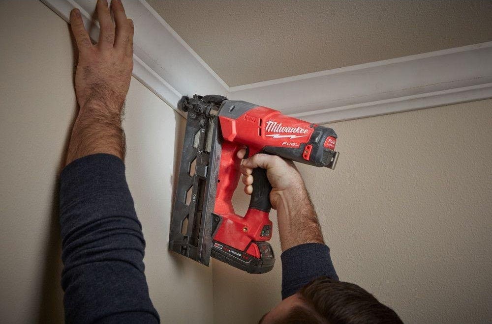 hand using Milwaukee M18 Cordless Angled Finish Nailer