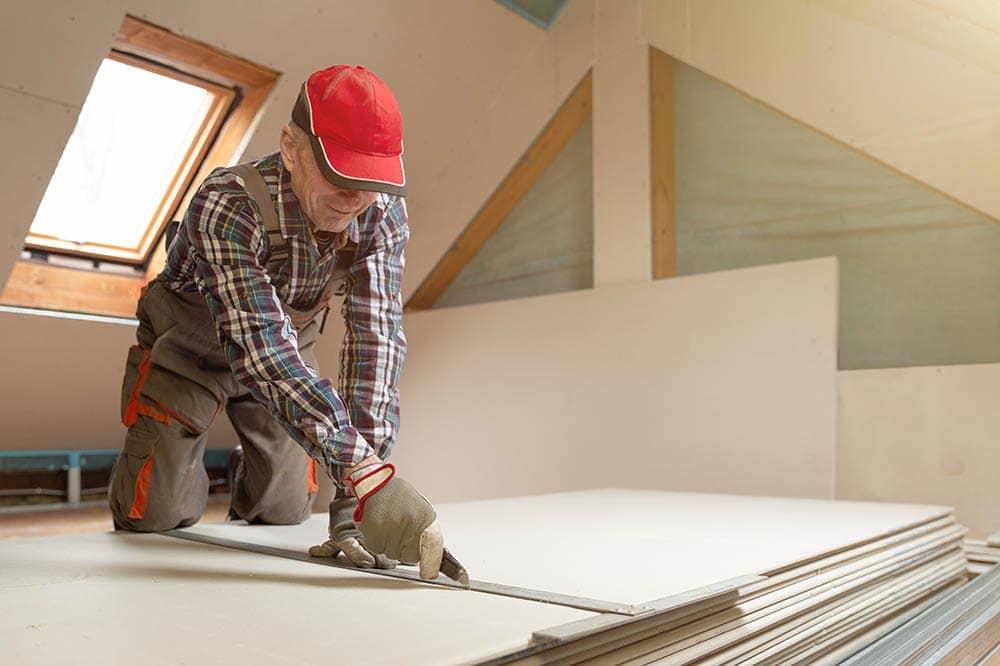 Man Cutting Drywall Arturs Budkevics Shutterstock 