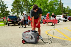 man using Briggs & Stratton P3000 Inverter Generator