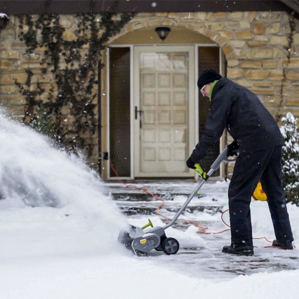 man using Earthwise SN70016 Electric Snow Shovel