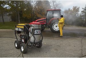 man using NorthStar Gas Wet Steam and Hot Water Pressure