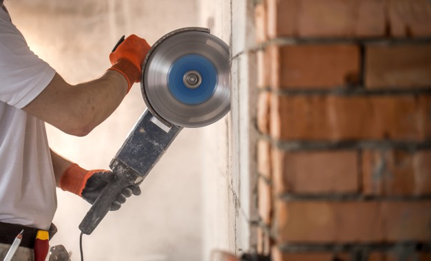 man using angle grinder