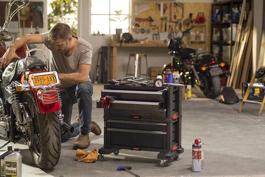 man with Keter Rolling Tool Chest beside him