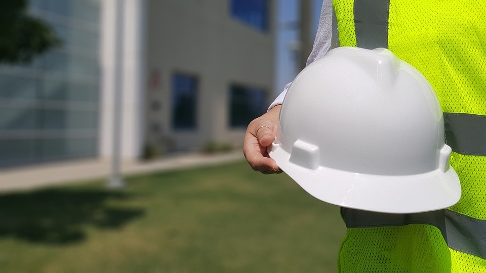 person holding hard hat
