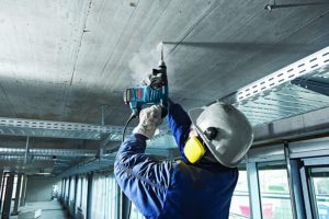 person using Bosch RH328VC SDS Rotary Hammer Drill