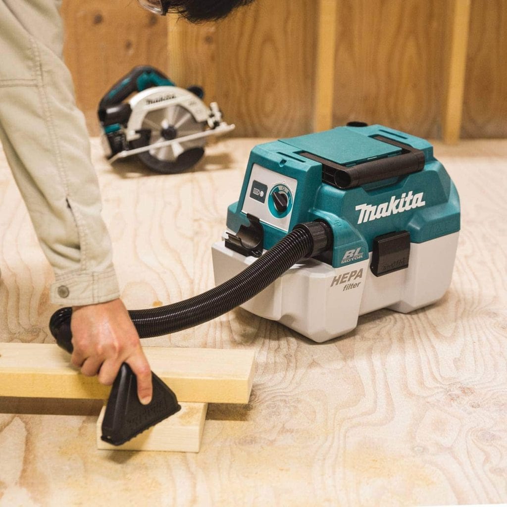 person using Makita XCV11Z Brushless Cordless Wet:Dry Vacuum