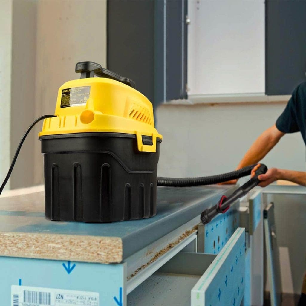 person using Stanley Wet Dry Vacuum, best small shop vac