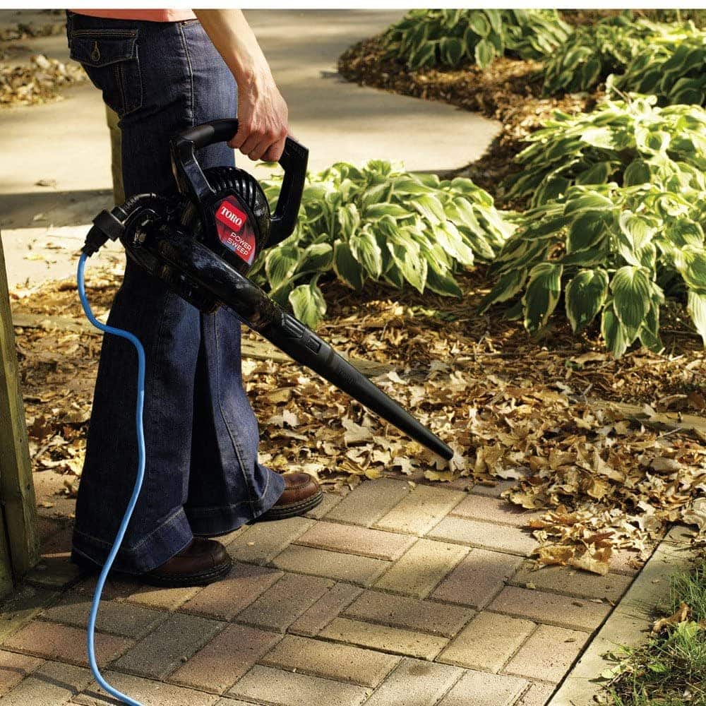 person using Toro 51585 Power Sweep Electric Leaf Blower