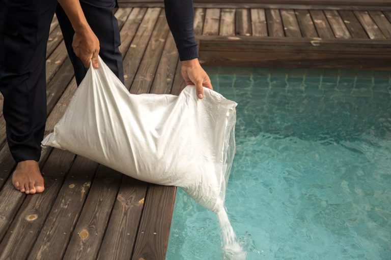 Man Putting Salt In The Pool Bignai Shutterstock 768x512 