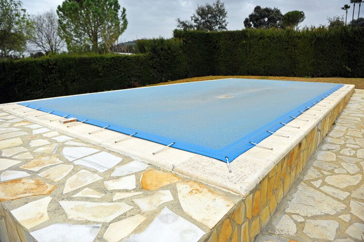 pool covered with blue tarp for winter