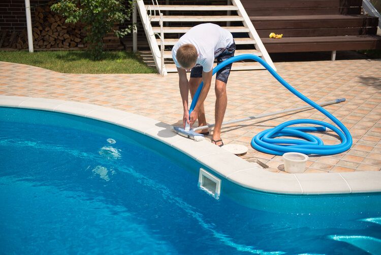 man cleaning pool