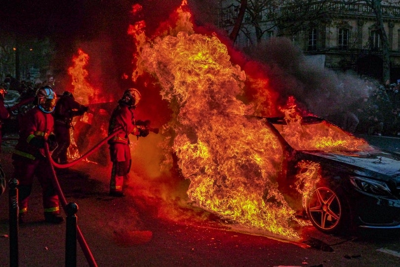 firefighters extinguishing burning cars