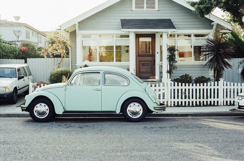 house with vintage cars