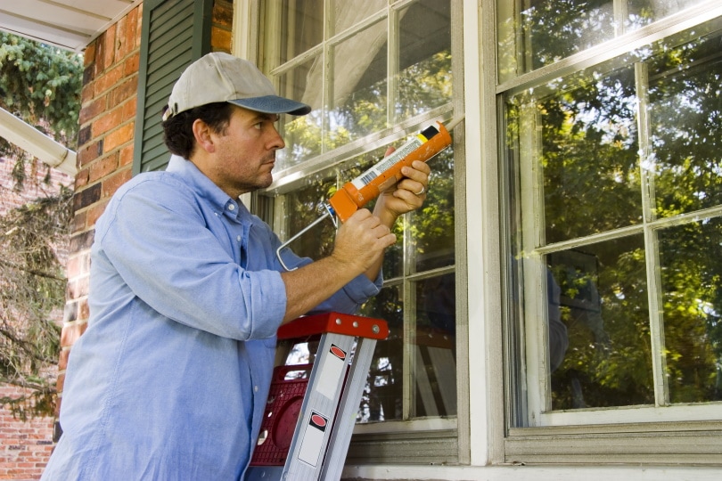 man doing window repair