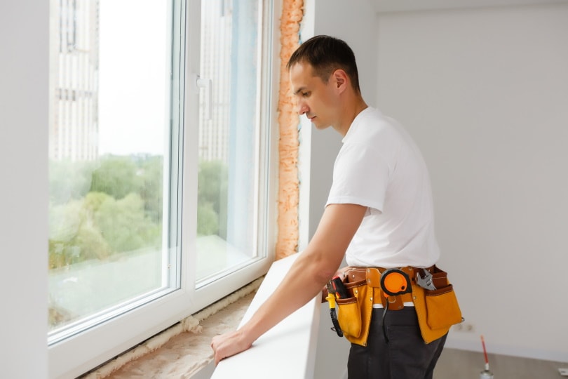 A Man replacing windows at a home