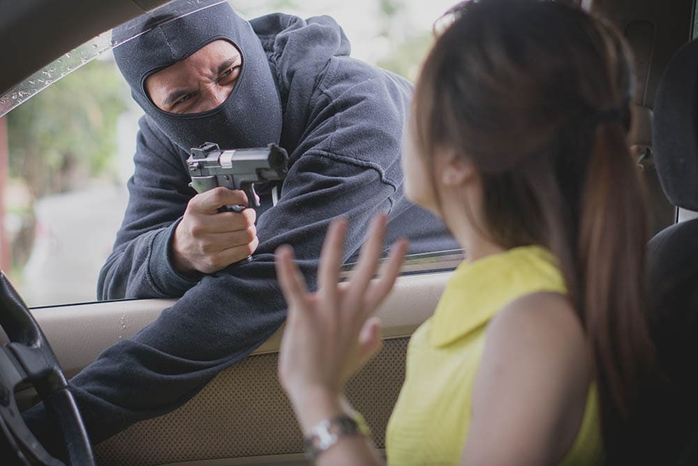 man carjacking woman's car