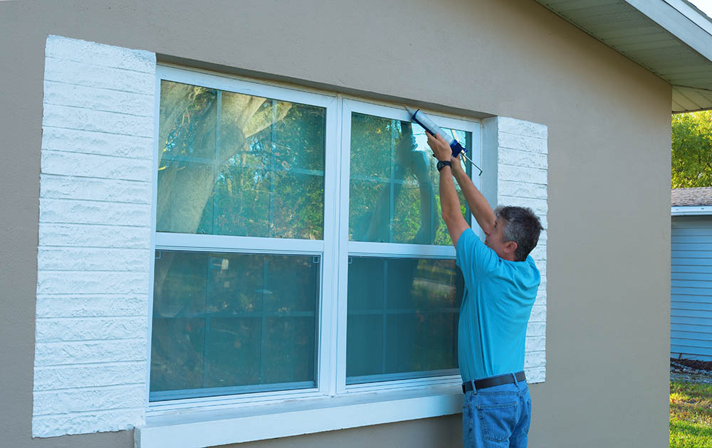 man installing storm window