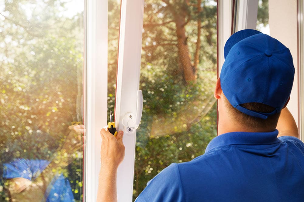 man installing window