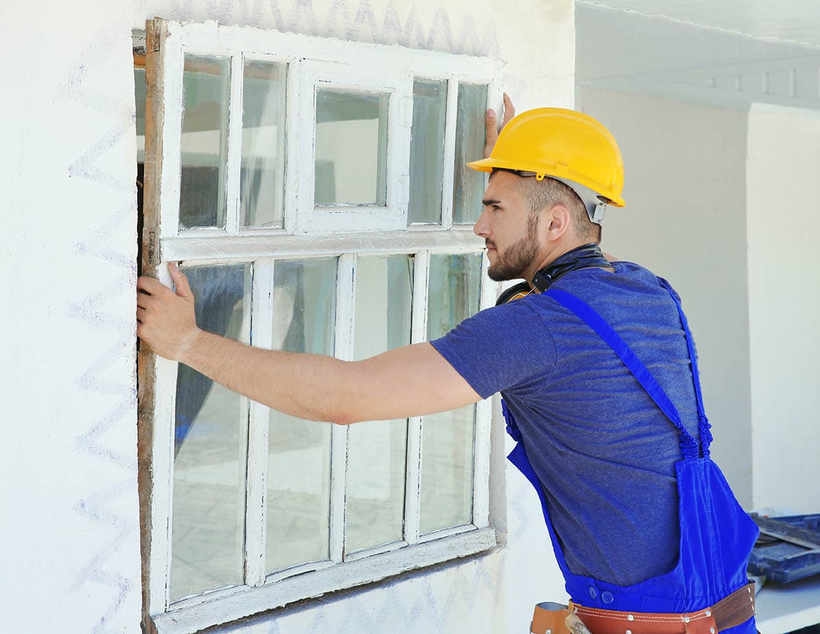 man removing old window