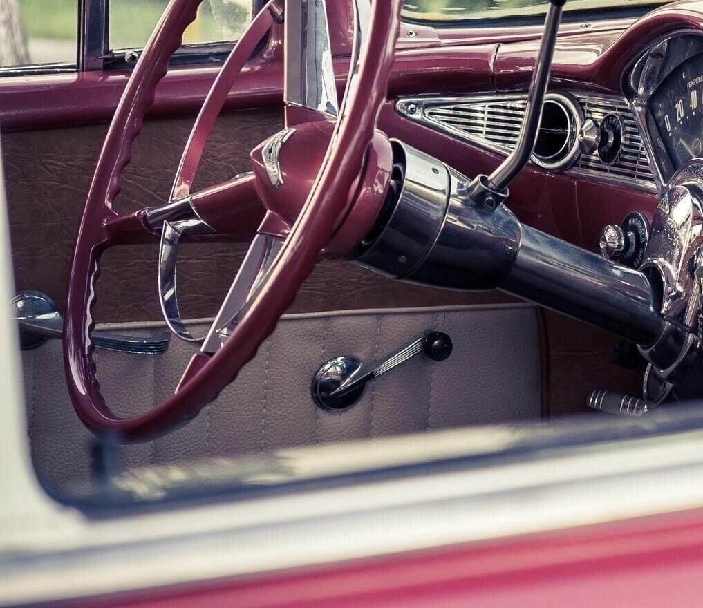 Selective Focus Photography of_. Red Vehicle Interior car window crank
