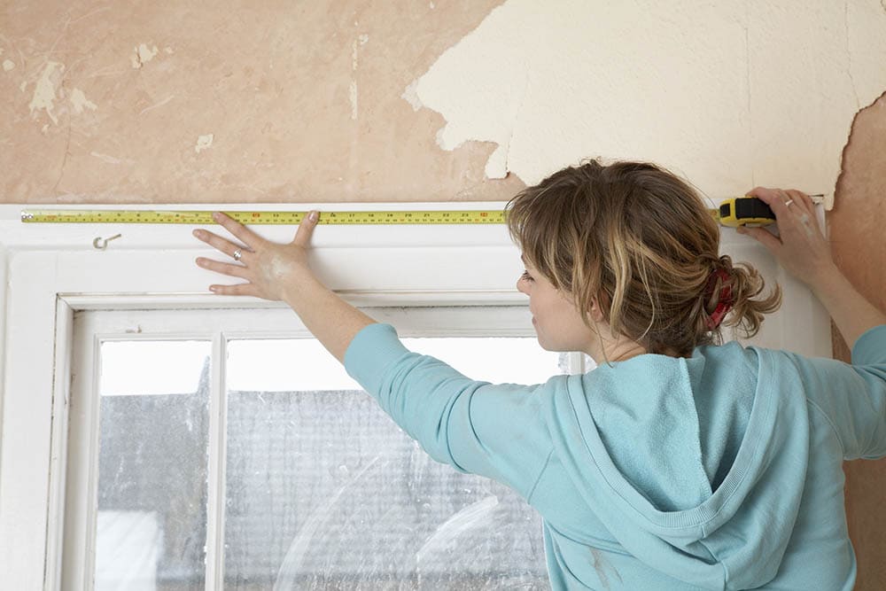 woman measuring window