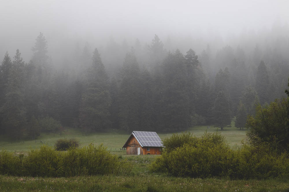 house with solar panels on a foggy cloudy day