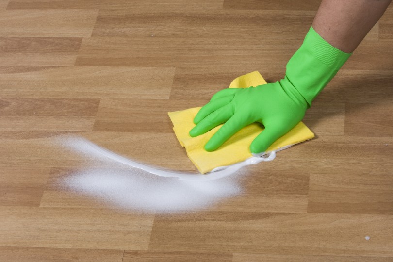 man cleaning wooden floor
