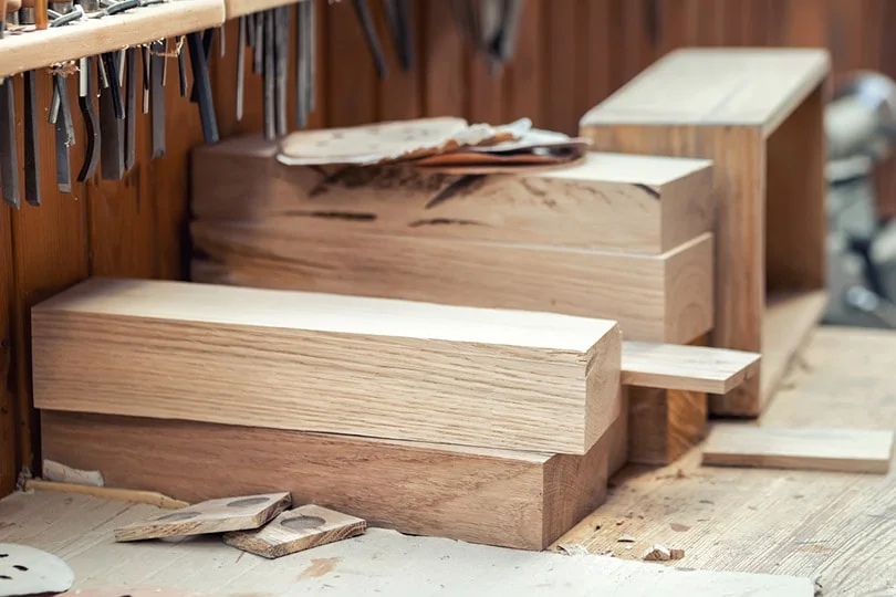 oak-wooden-bar-blocks-stacked-at-carpentry-woodwork-workshop-with-tools_Gorlov-KV_Shutterstock.webp