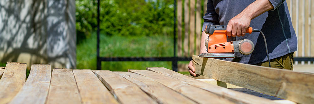 person sanding lumbers