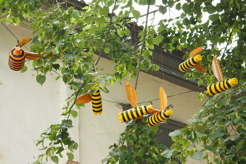bees under a tree made of plastic bottles