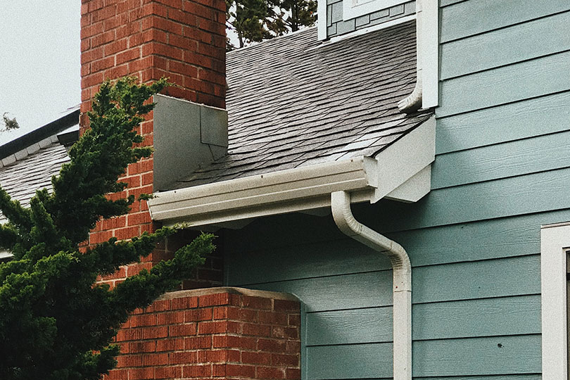 exterior of a house showing the gutter and downspout