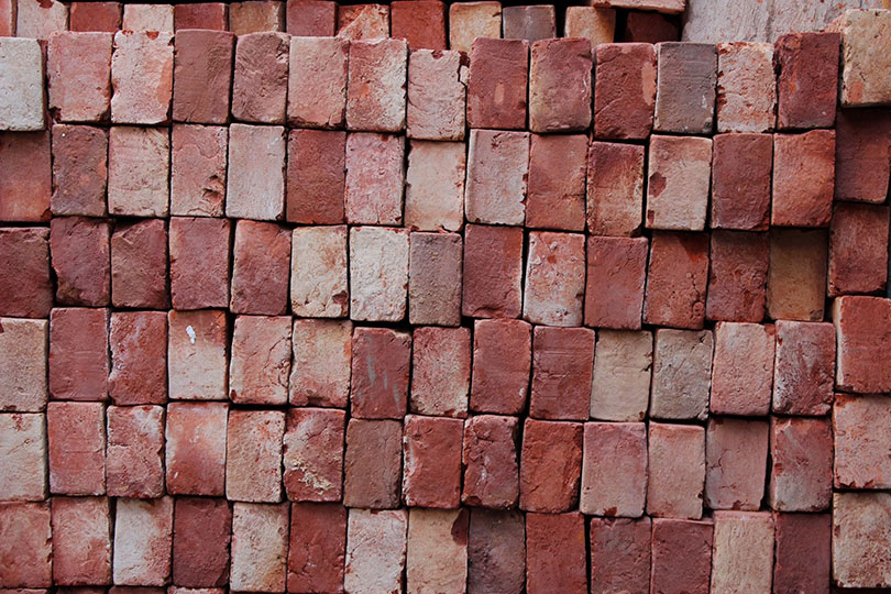 How To Hang Things On Brick 6 Ideal Options House Grail   Stacked Used Bricks Ansh Bhagania Unsplash 