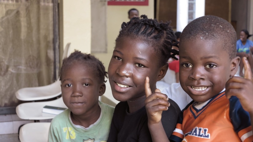 three smiling black children
