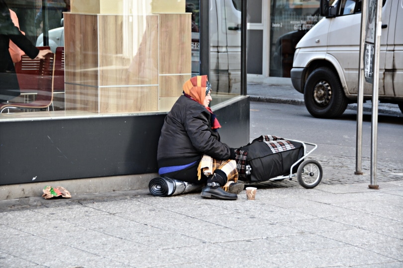 woman sitting beside road