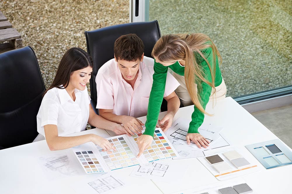 Couple Discussing With Interior Designer Robert Kneschke Shutterstock 