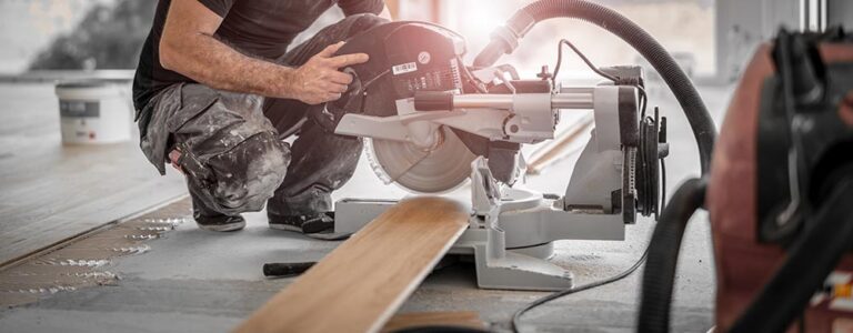 Person Cutting Wood Plank Using Chop Saw Anselm Kempf Shutterstock 768x300 