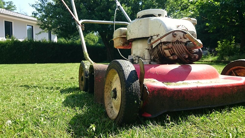 Red Old mower in the garden
