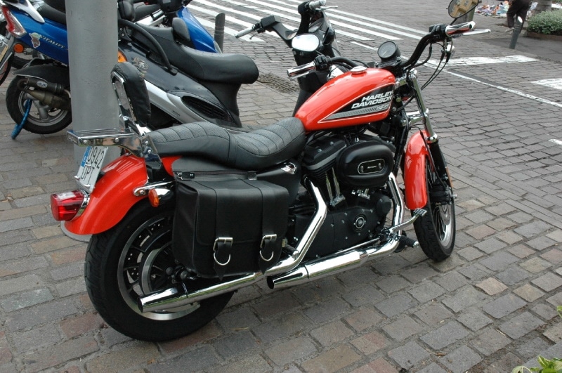 Black and orange Harley Davidson motorcycle with chumps handlebars
