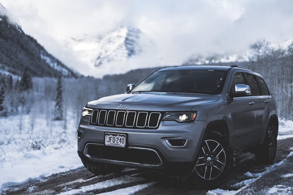 grey Jeep compass on the road during winter
