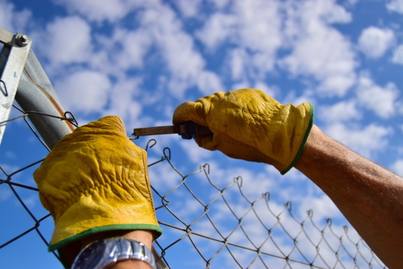 man repairing fence