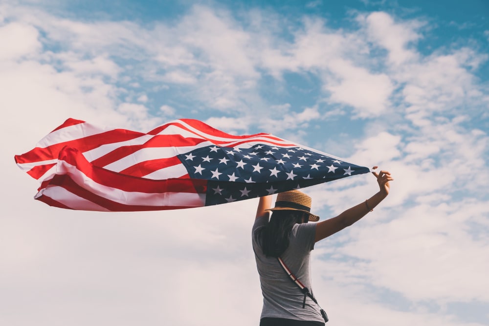 asian woman holding American flag