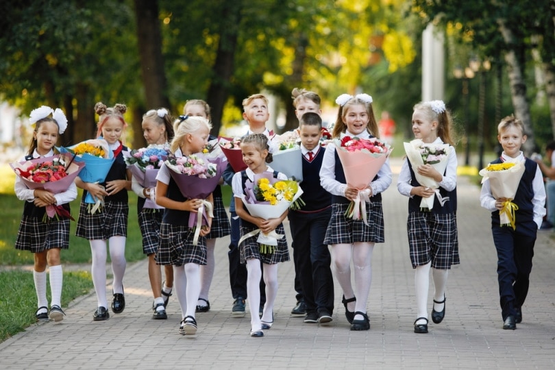group of schoolchildren with flowers