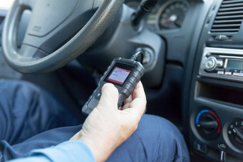 man using car code reader