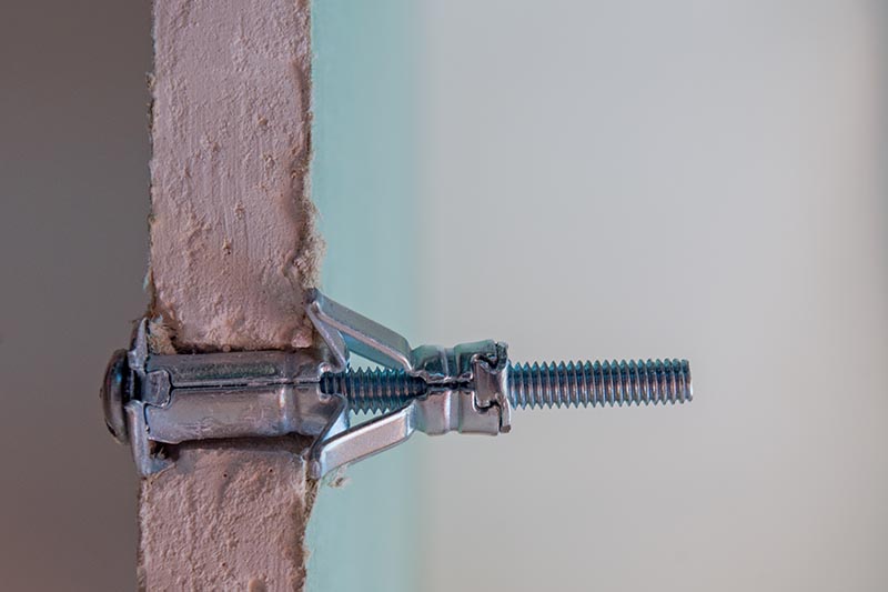 split view of a drywall anchor installed