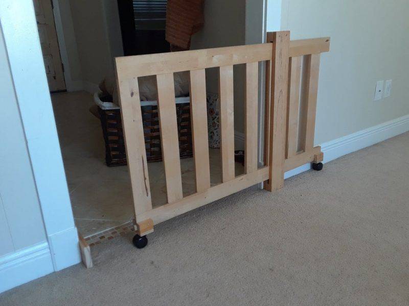 DIY sliding dog gate from reclaimed futon frame