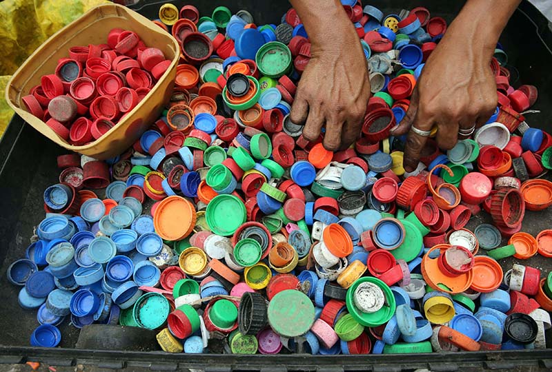 Person Hands on Assorted-color Plastic Lid bottle caps