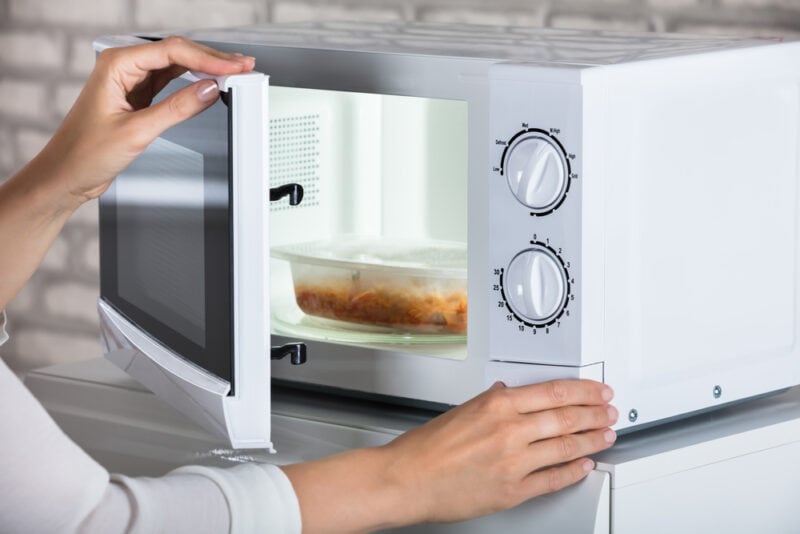 Who Invented The Microwave Oven History Safety Advantages House   Womans Hands Closing Microwave Oven Door And Preparing Food At Home Andrey Popov Shutterstock E1667982277533 