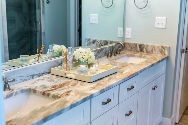 Modern Bathroom With Granite Countertops And A Tile Floor And Double Sinks Ursula Page Shutterstock 