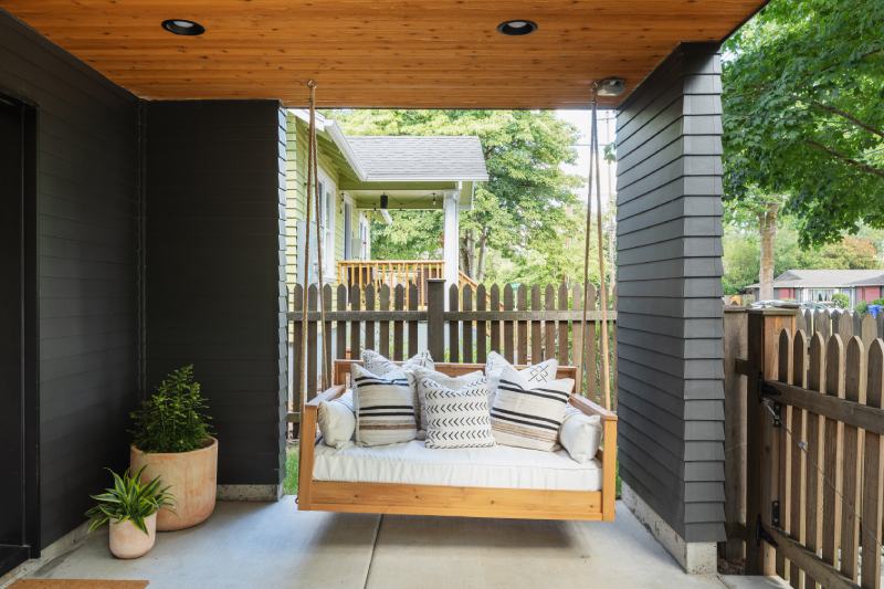Cozy outdoor living with swing on porch